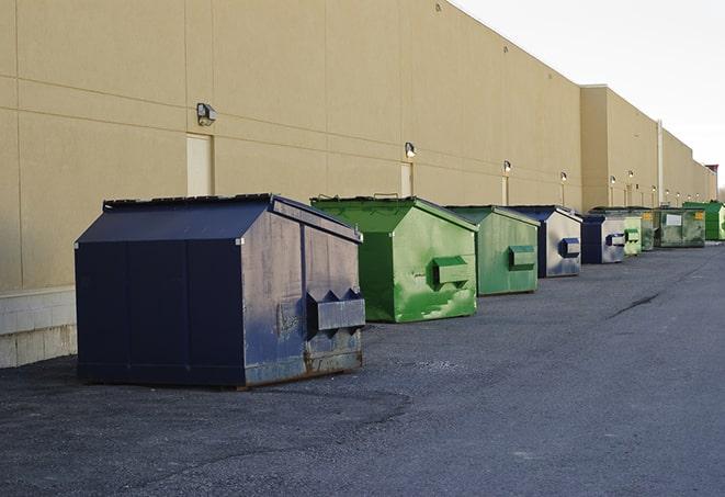 construction crew disposing of building materials in large bins in Bellbrook